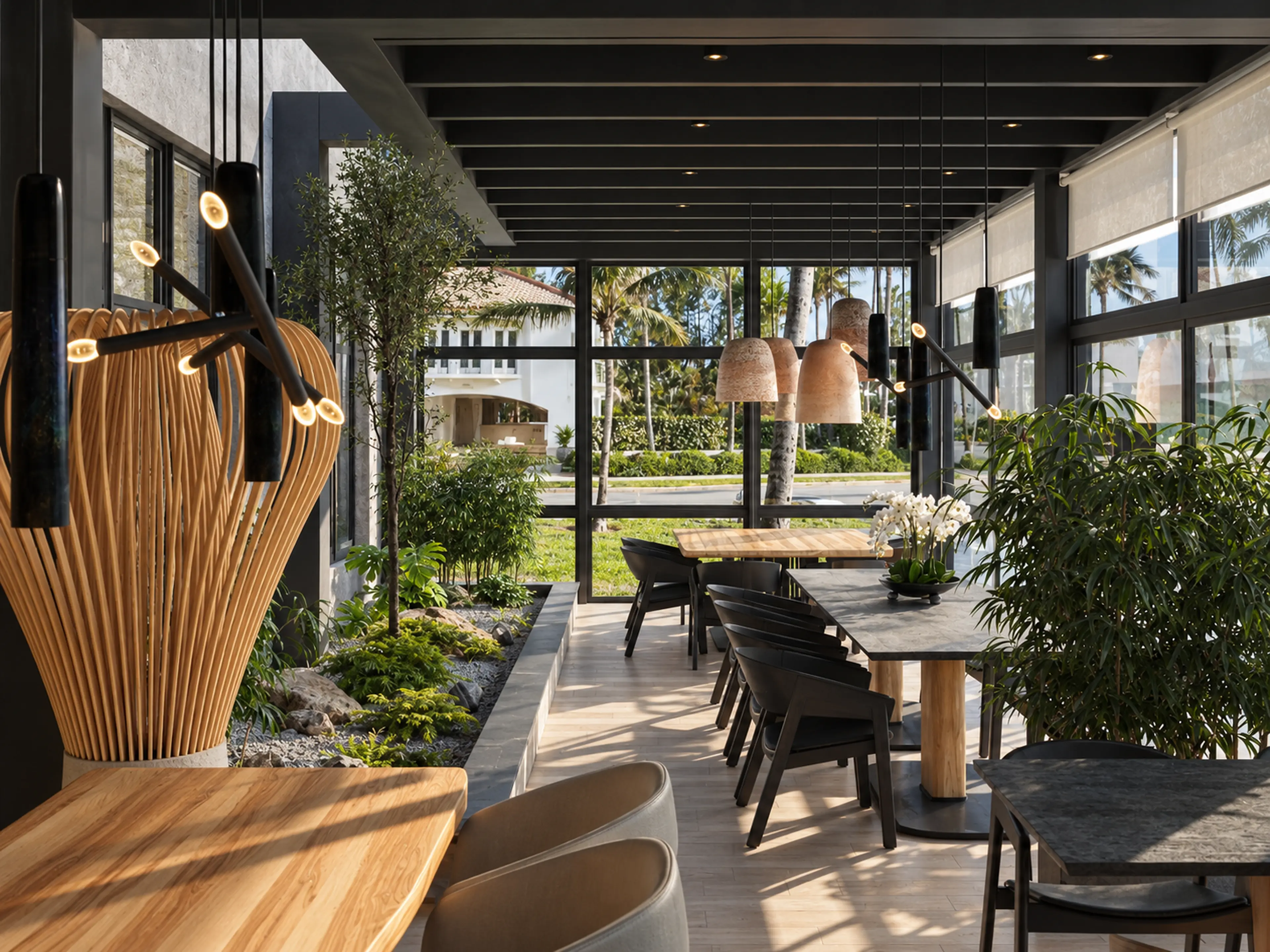 Restaurant dining room with sculptural wood lighting and planting.