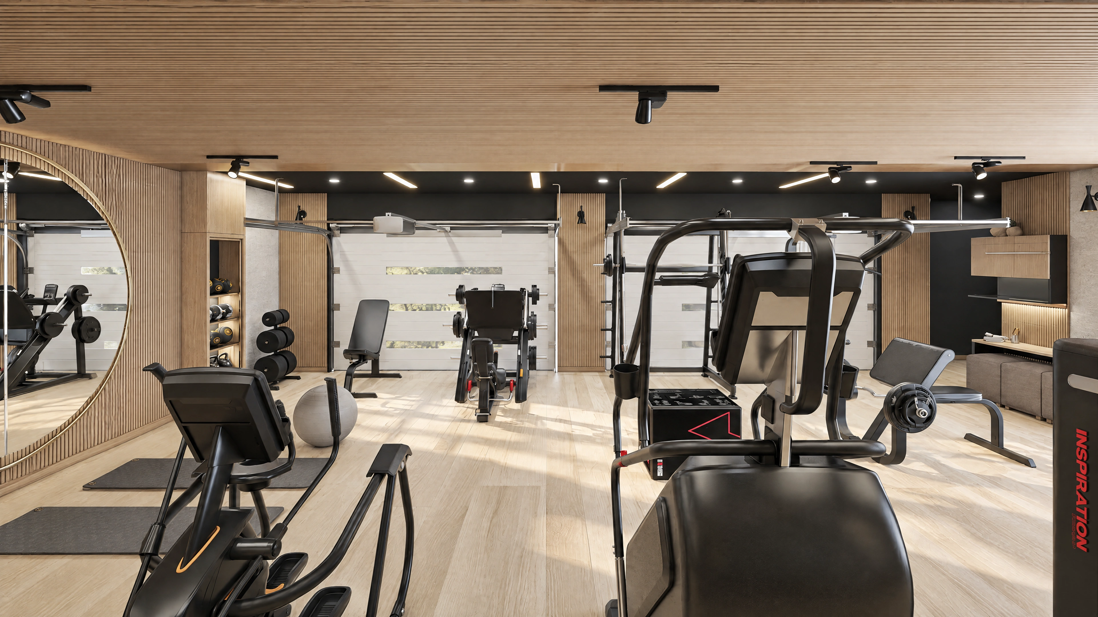 Wide fitness room view showing cardio and strength equipment.