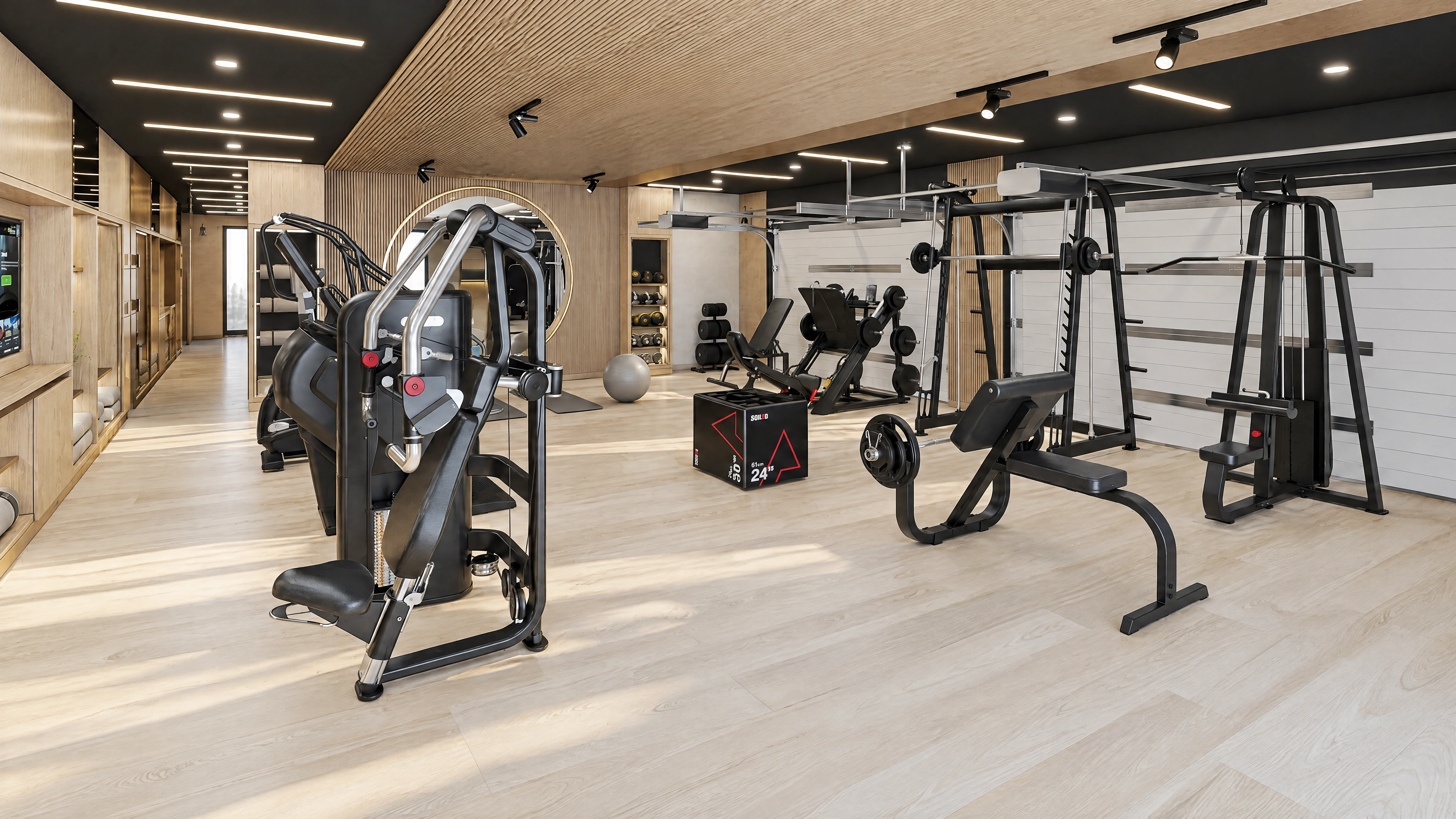 Fitness room with strength equipment and mirrored walls.