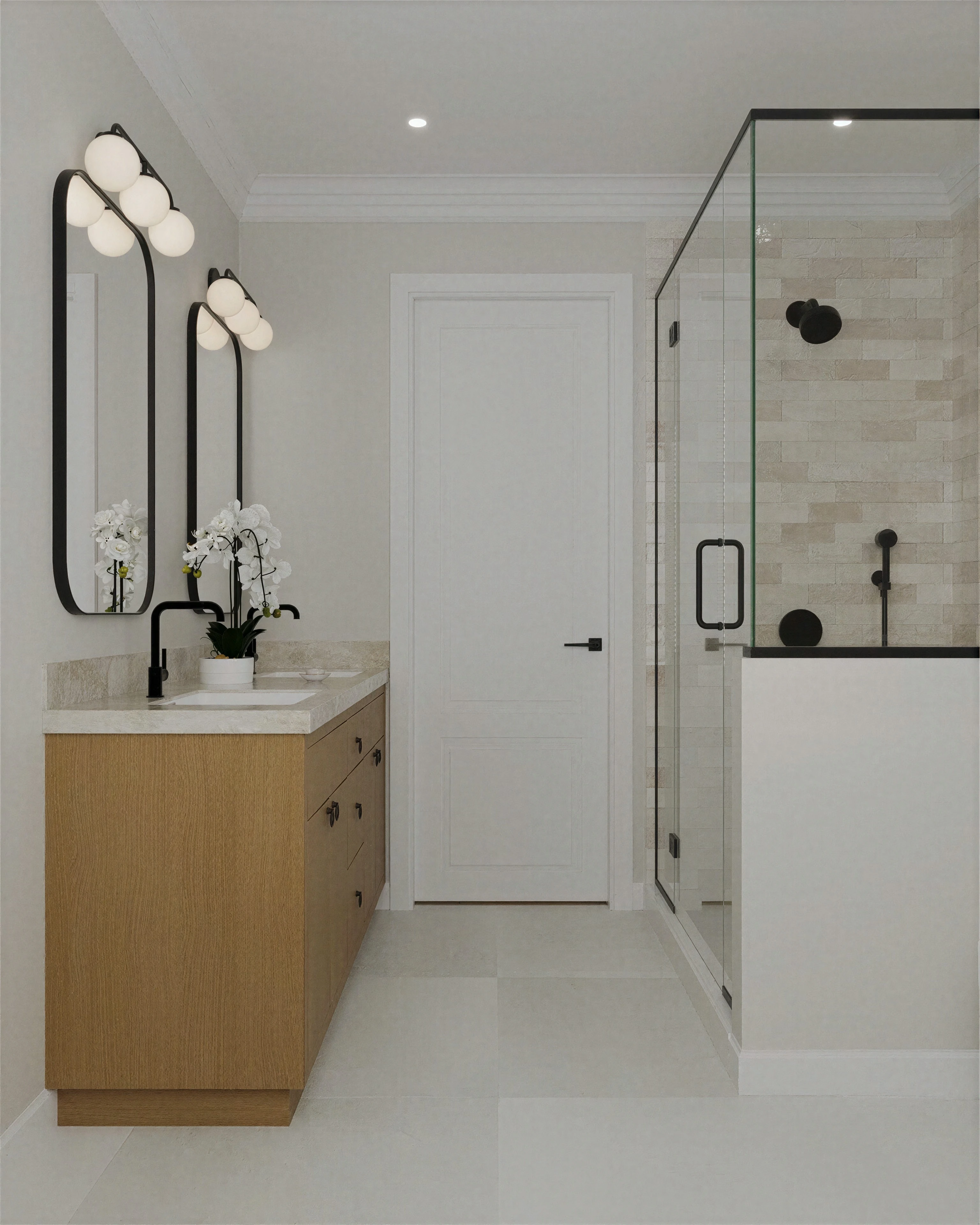 Bathroom vanity beside a glass shower enclosure.