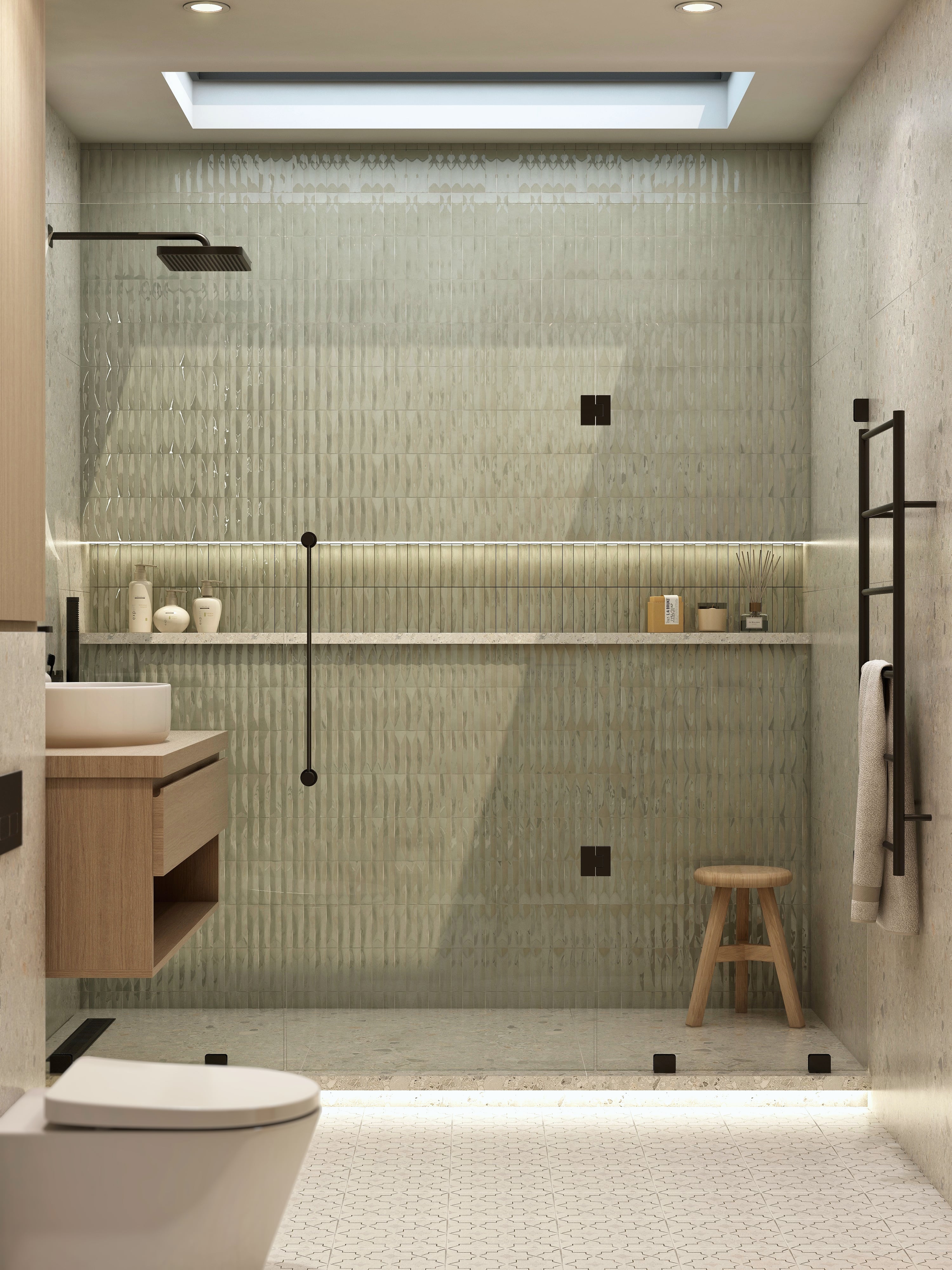 Glass shower enclosure with green tile and a built-in shelf.