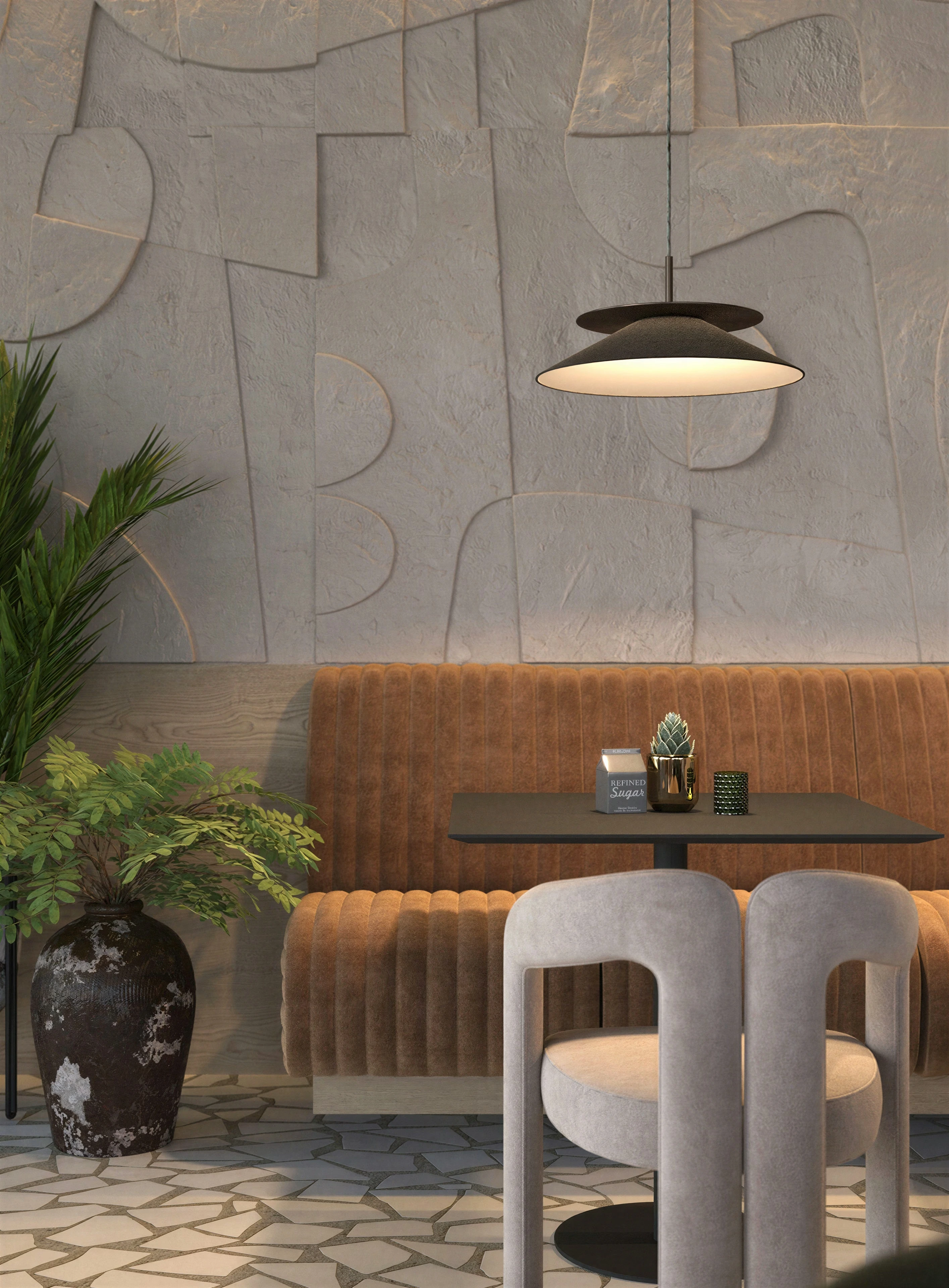 Detail of upholstered booth seating beneath a pendant light.