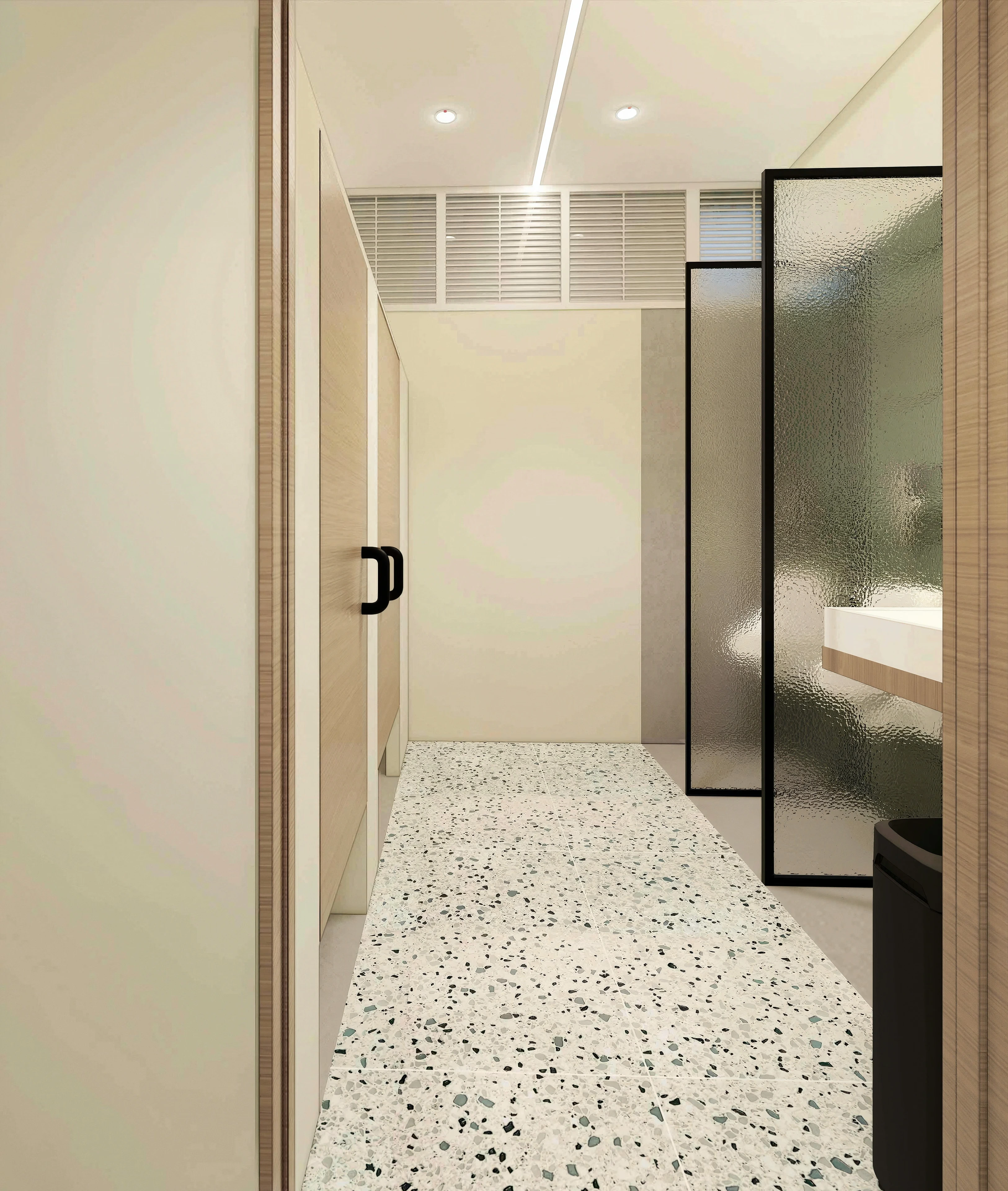 Shower corridor with glass doors and small floor tiles.