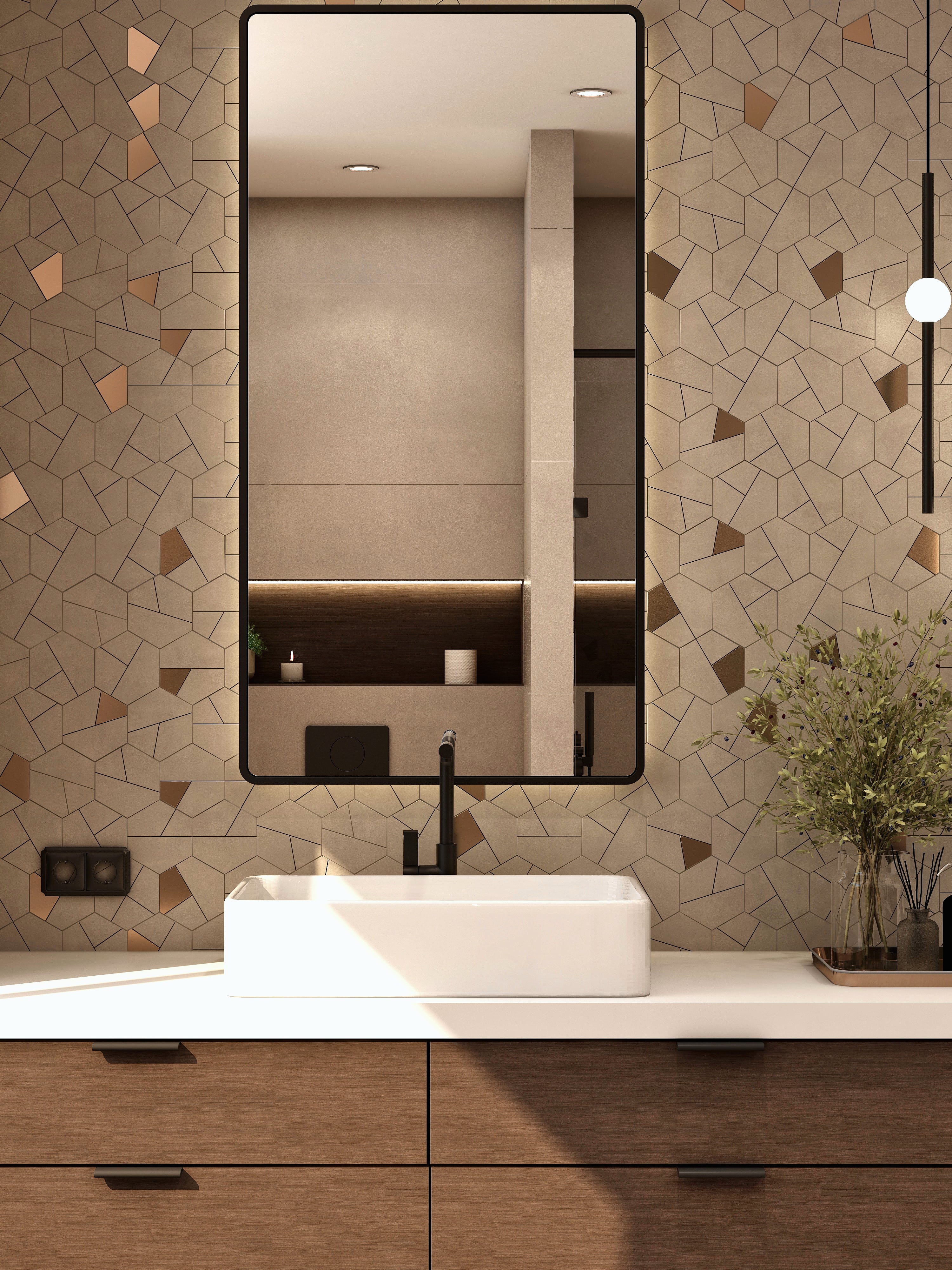 Close view of a vessel basin and bathroom mirror.