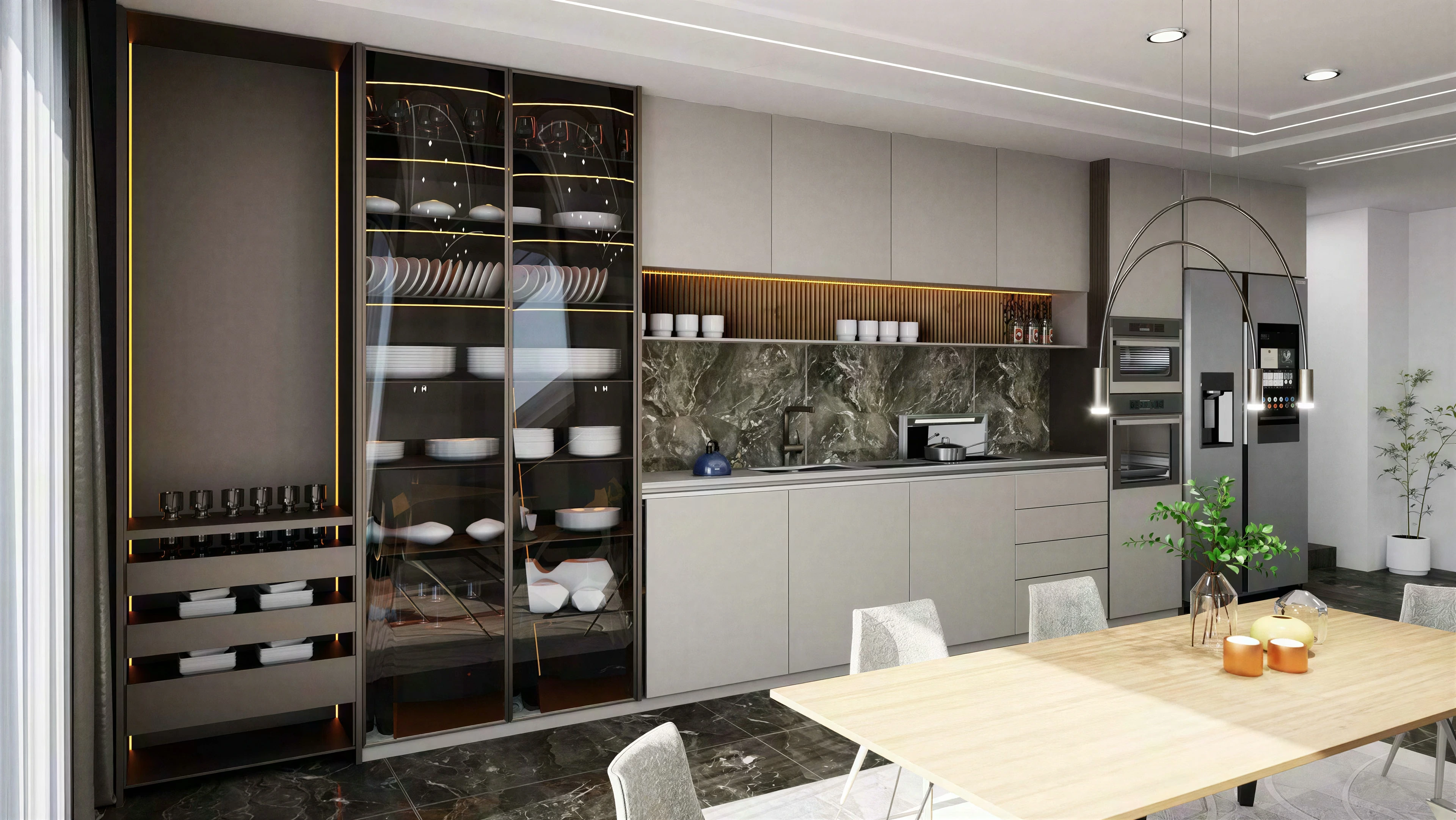 Kitchen cabinetry and dining table beneath curved pendant supports.