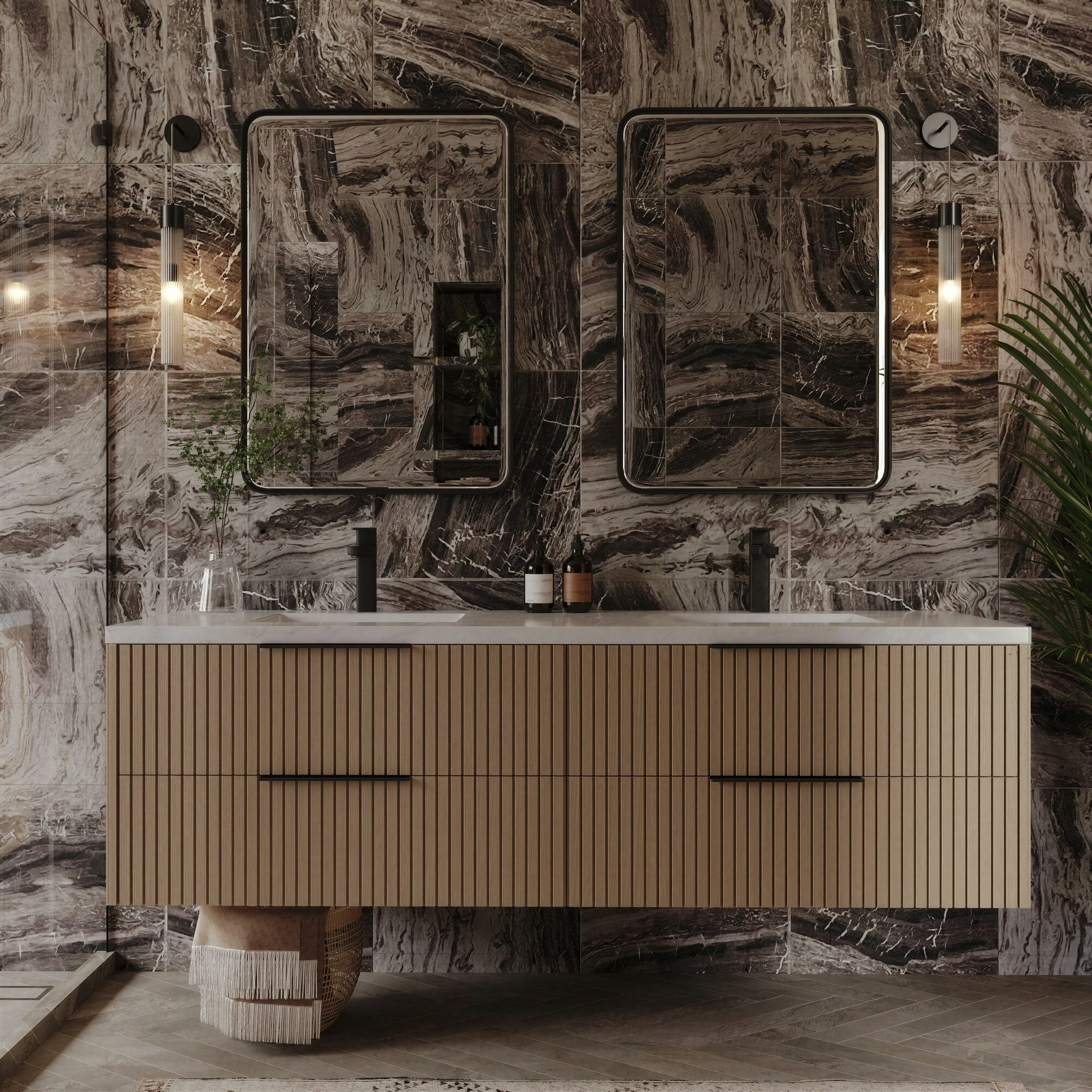 Bathroom vanity against a richly patterned stone wall.