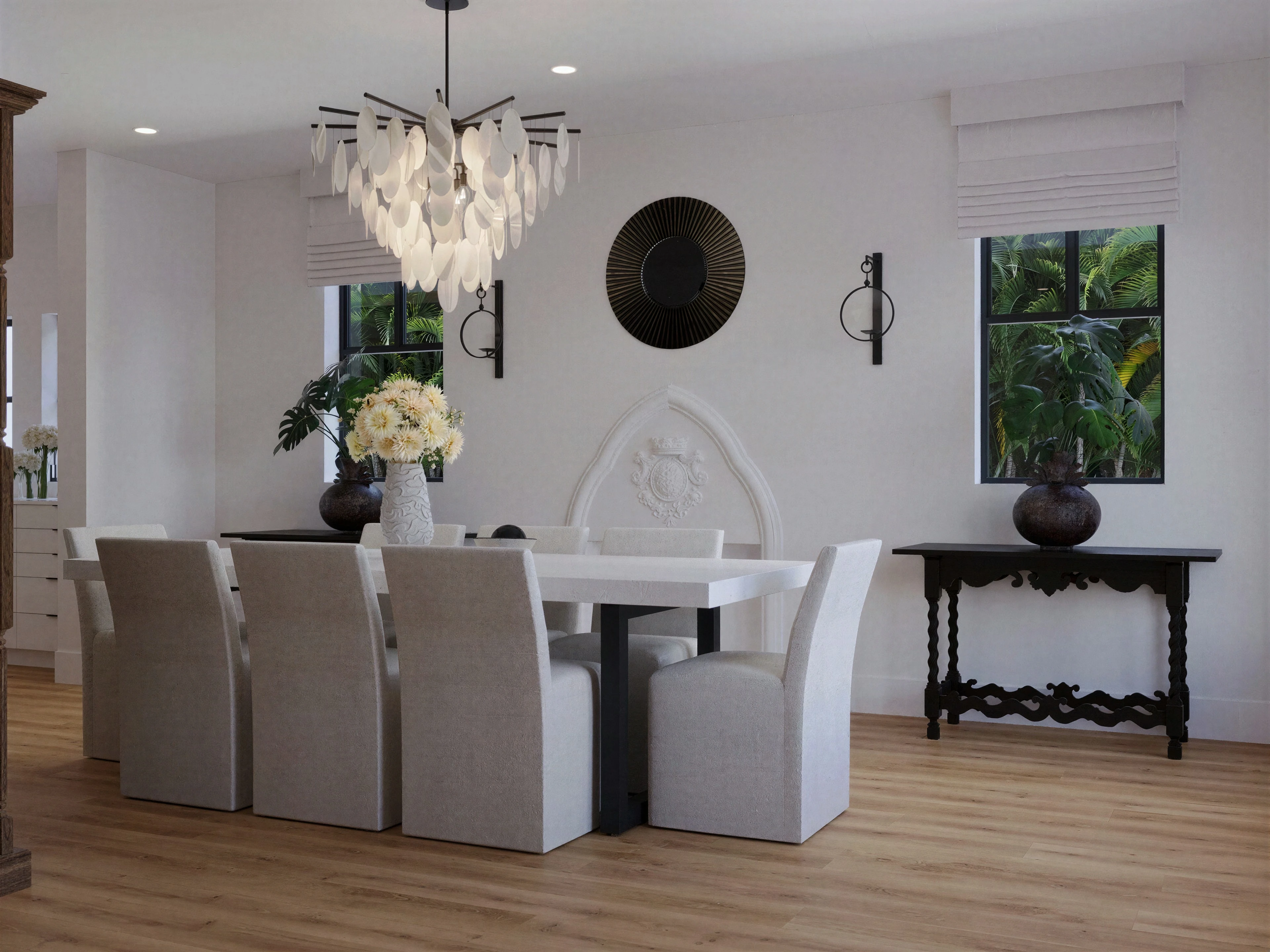 Dining room with upholstered chairs and a chandelier.