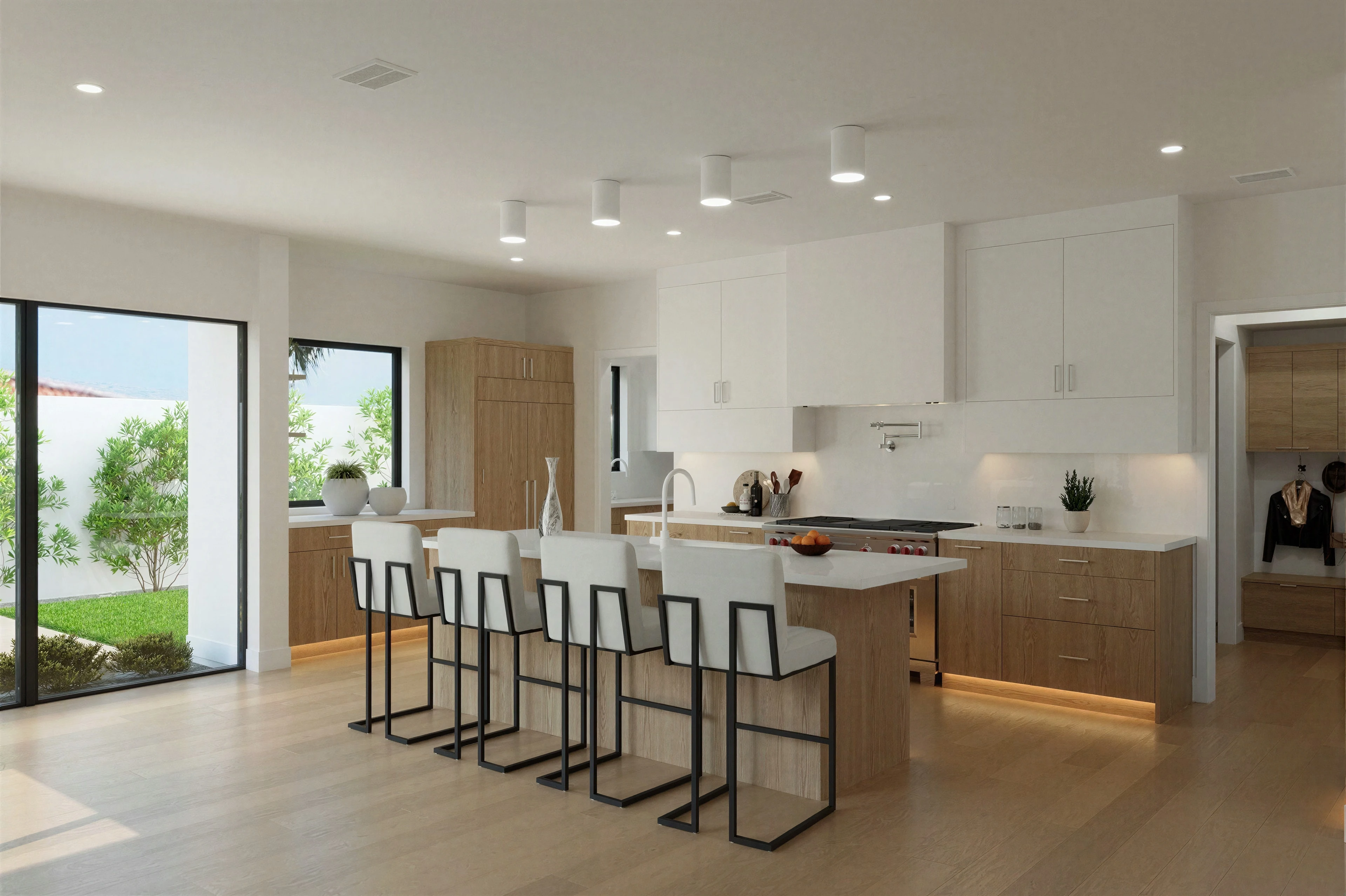Open kitchen with island seating and large glass doors.