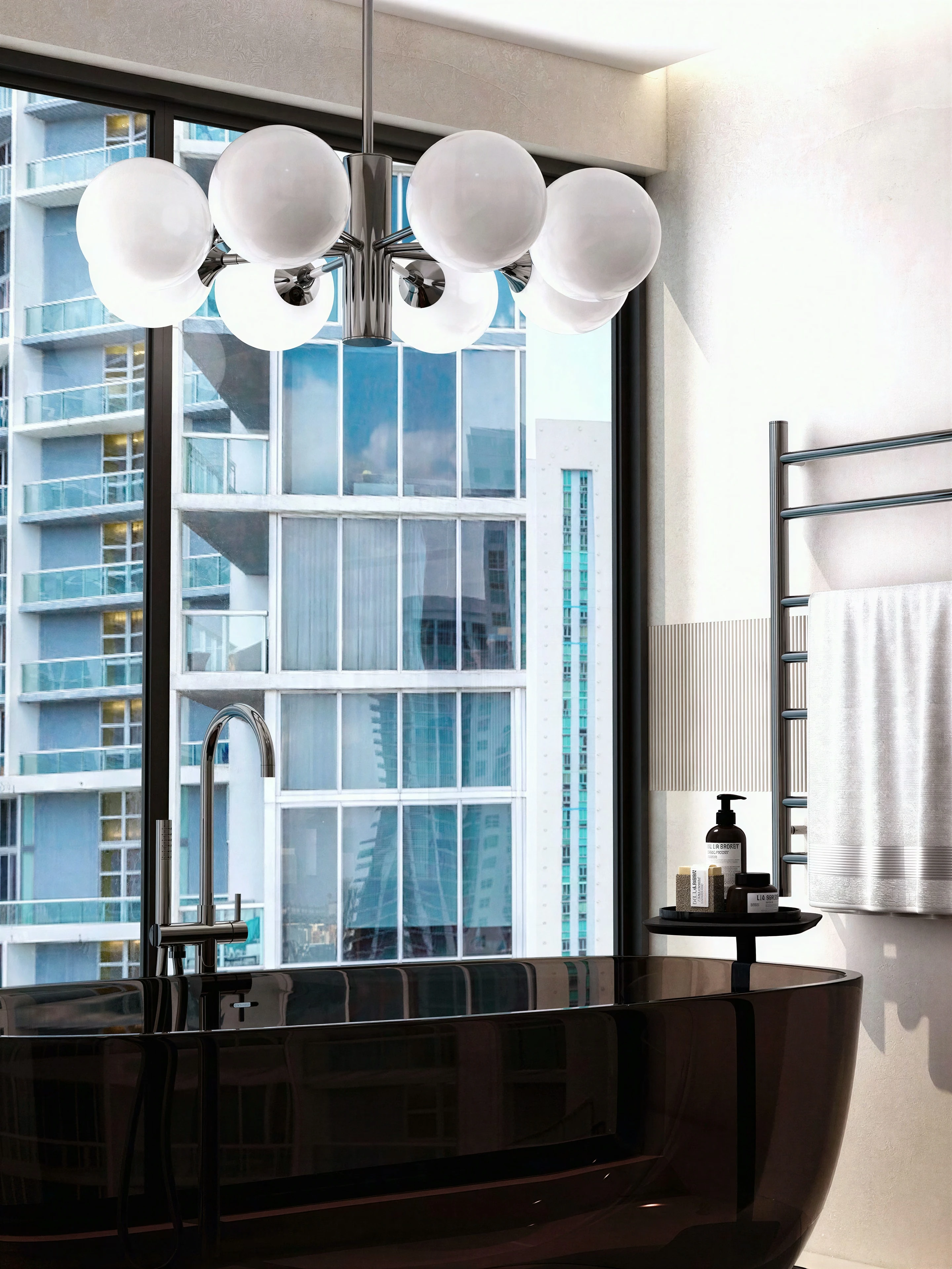 Freestanding tub beside tall windows and pendant lights.
