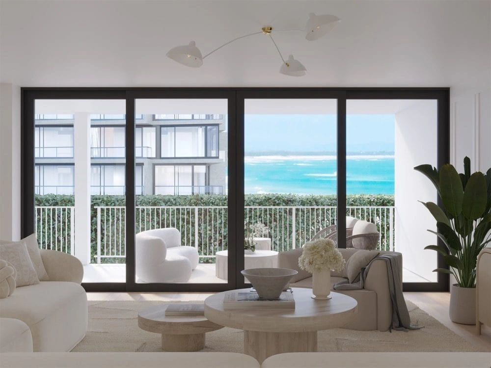 Project rendering: living room opening to the balcony through full-height glazing.