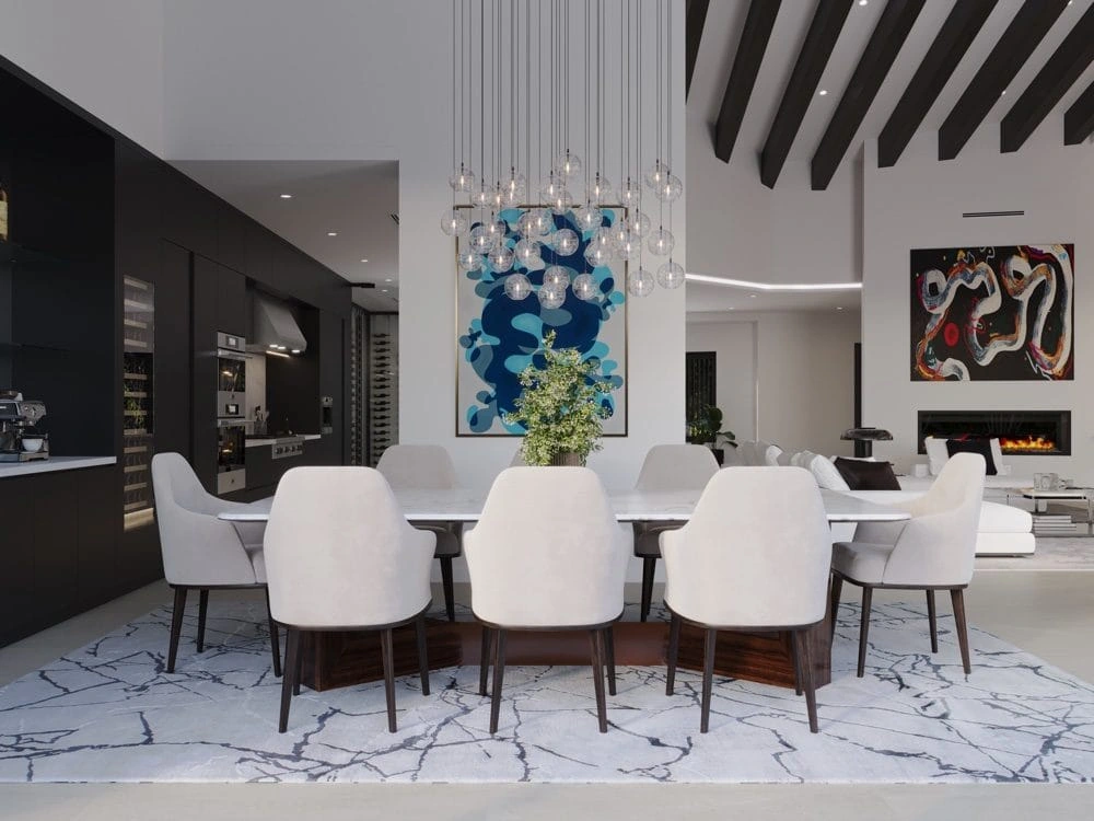 Project rendering: dining table beneath glass pendants, beside the kitchen and fireplace.