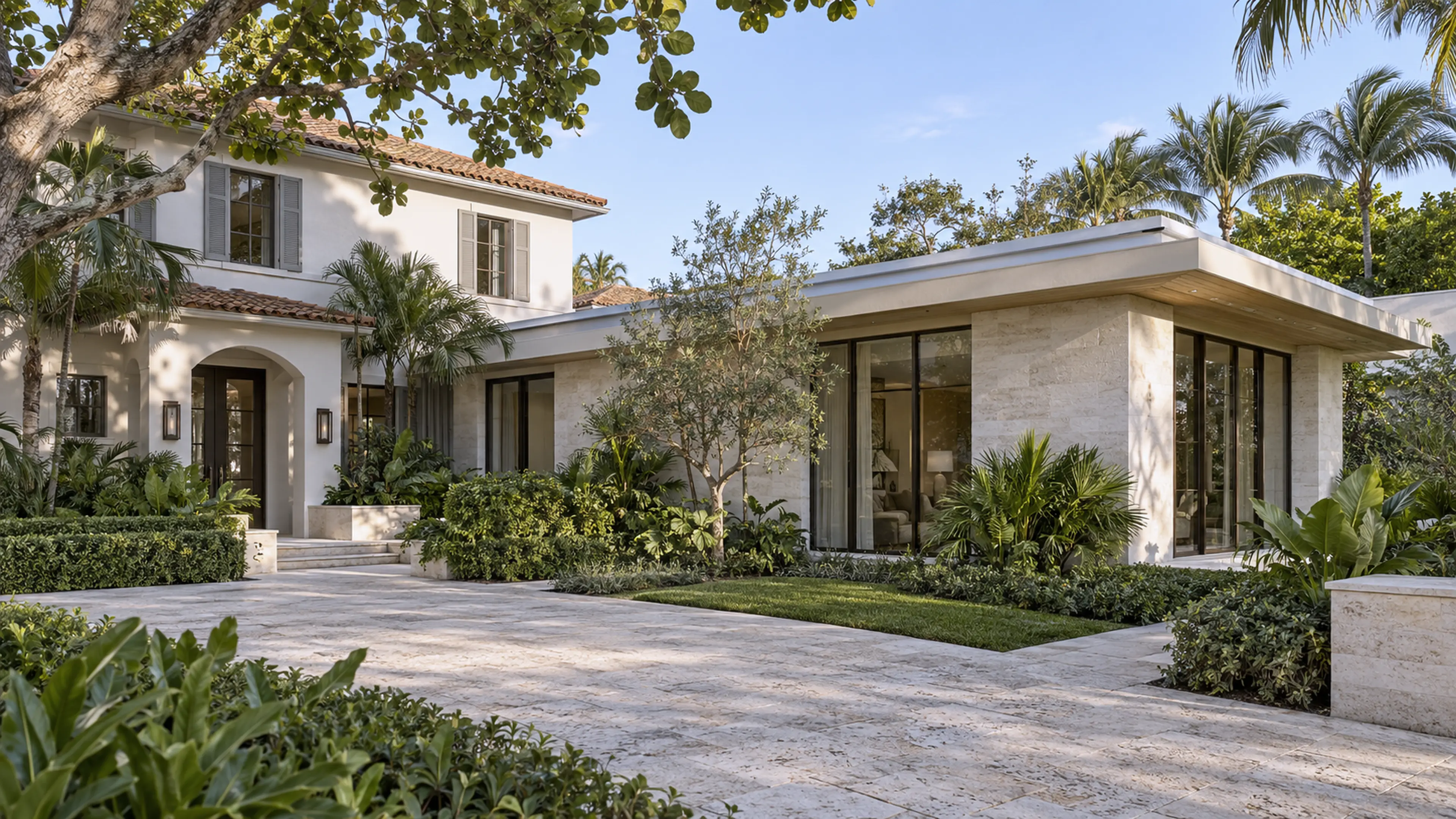 Completed Delray Beach coastal home with a seamless limestone-and-glass garden-wing addition.